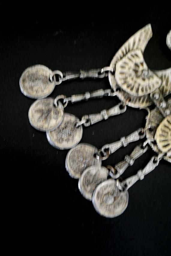 "Boho vintage 70s, silver tone metal necklace. One strand , chunky long chain. Accented with a hand made, hammered, large, geometric , brass pendant and dangle, antique coins tassel. Different. Look like the anchor , but it's not. Could be some symbol. Exotic,statement, stylish, rare. Excellent condition. Clean. No any damage, no discoloration, no missing parts. You can use as a gift. Length of the chain:28,0\" Size of the pendant with a tassel:4,5\"x2,75\" Length of the tassel :1,5\" Size of th Vintage Metal Necklace With Coin Pendant, Handmade Metal Medallion Necklace For Festivals, Vintage Metal Coin Pendant Necklace, Vintage Metal Medallion Necklace With Coin Pendant, Vintage Metal Coin Necklace, Handmade, Vintage Coin Necklace With Large Pendant, Vintage Handmade Metal Medallion Necklace, Silver Coin-shaped Medallion Necklace In Brass, Handmade Vintage Metal Medallion Necklace