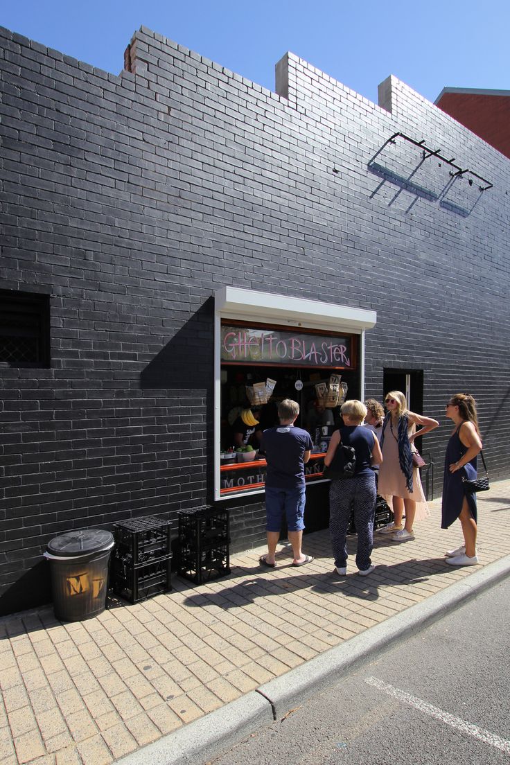 some people are standing in front of a food stand