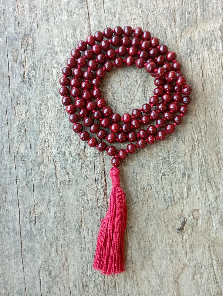 📿This mala is made from genuine naturally fragrant Red Sandalwood Beads. The Beads are embedded with a durable nylon silk cord for more endurance. This mala finishes off with a silk tassel decked up with silver zari. This mala unfolds vibrant energy and gives bravery, strength and will power as per ancient Vedic texts. The wearer enjoys all comforts at his command but still remains unattached. It is used for peace and empowering rituals and for worshipping all deities. It promotes tranquillity Sandalwood Mala, Red Sandalwood, Knotted Mala, Power Red, Silk Gifts, 108 Mala Beads, Vibrant Energy, Silk Cord, Mala Necklace