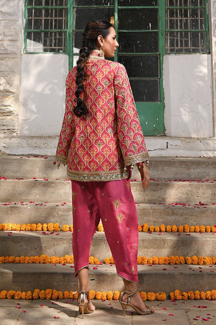 A fresh spin on a classic silhouette - a coral printed khaddi silk jacket with gota and zardoze work and colourful tassel details. The look is completed with a coral raw silk shalwar embellished with embroidered floral motifs. Bridal Suits Punjabi, Bridal Suits, Suits Punjabi, Coral Print, Boutique Dress Designs, Website Features, Boutique Dress, Silk Jacket, Indian Designer