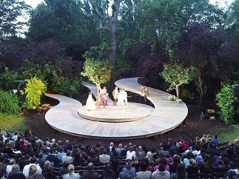 an aerial view of a stage with people sitting on it