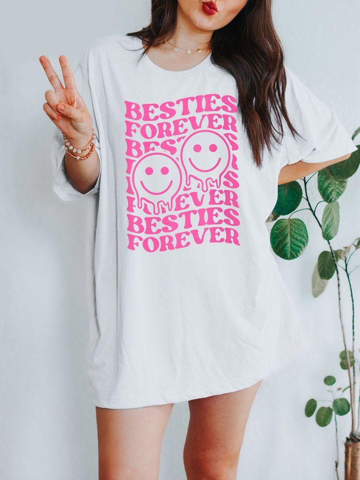 Get ready to be OBSESSED with your new Besties Forever + Smiley Faces t-shirt. It's the coolest and most comfortable way to show off the latest styles. Also makes a great gift for your best friend! LOOKING FOR THE SWEATSHIRT? ► https://www.etsy.com/listing/1169273981 * PRODUCT DETAILS * ↠ High Quality, Super Soft & comfy Bella + Canvas T-Shirt ↠ 100% pre-shrunk cotton (heather colors are a poly-cotton blend) ↠ This is a direct-to-garment print, no vinyl or stencils. Which means it will last a lo Oversized Pop Culture Tops With Screen Print, Oversized Pop Culture Screen Print Tops, Oversized Screen Print Pop Culture Tops, Relaxed Fit Slogan Tops For Pop Culture, Pop Culture Slogan Tops With Relaxed Fit, Oversized Pop Culture T-shirt With Letter Print, Best Frind, Retro Smiley Face, Best Friend T Shirts