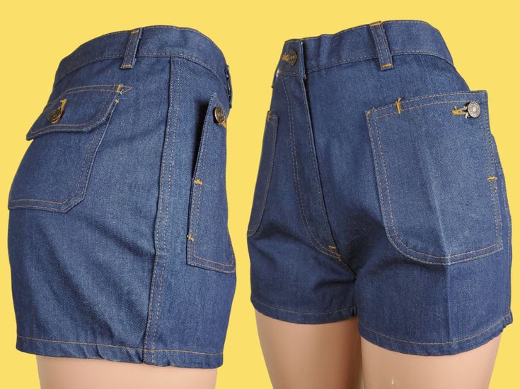 "Like new crisp dark wash twill denim shorts with a mid to high rise & short cut. To me, the fit is cute, but they're really all about the pockets! They're all flap patch pockets with buttons, but the 2 in front are so unique as the pocket can unbutton into a diagonal flap & are still accessible buttoned up. There are moderate belt loops & a robust metal zip fly with a button closure. The topstitching is burnt orange. ♡ LABELS & SIZING Made in the 70s in Thailand. There's not any branding anywhe Retro Denim Bottoms With Built-in Shorts, Medium Wash Jean Shorts With Hip Pockets, High Waist Medium Wash Shorts With Hip Pockets, Denim High-waisted Shorts With Hip Pockets, Retro Dark Wash Bottoms With Pockets, Fitted Dark Wash Jean Shorts With Pockets, Fitted Retro Denim Shorts, Retro Mid-rise Denim Jean Shorts, Retro Fitted Denim Shorts