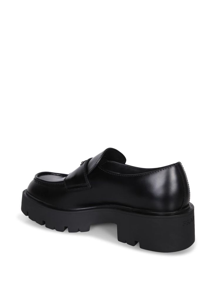 Glossy black leather loafer. Thick rubber sole. Prominent stitching details.. This Prada loafer blends the elegance of shiny leather with the practicality of a robust, sculpted rubber sole for superior comfort. Refined details like prominent stitching add a distinctive touchGender: MenMaterial: 100% CALF LEATHERColor: BlackMade in: ImportedProduct ID: 2DG152 B4L F0002*Import tax/duty will be calculated at checkout (If applicable)