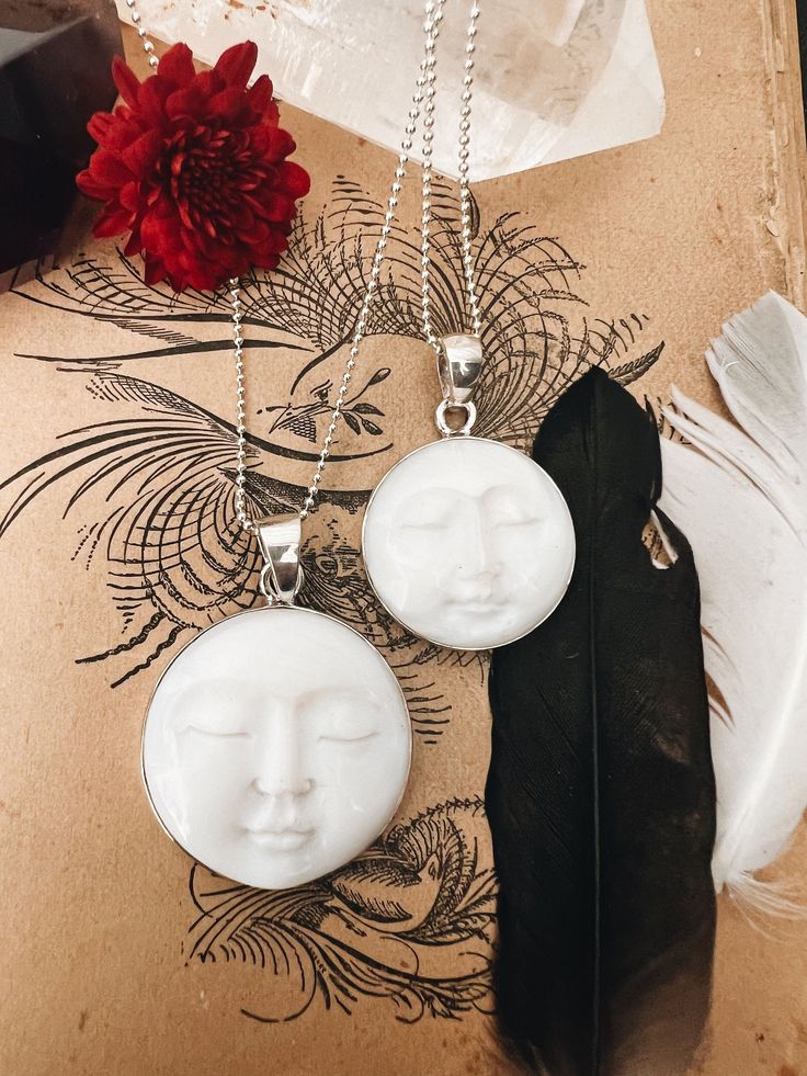 This enchanting Bone Pearl Moon Face necklace, set in sterling silver, captures the magic of the moon in a beautifully carved design. Available in two sizes, the moon face pendant radiates an ethereal charm, making it both a unique statement piece and a symbol of intuition and mystery. The bone pearl adds a natural, organic feel, while the sterling silver setting enhances its timeless elegance. Hanging from an 18" sterling silver ball chain, this necklace blends artistry and elegance, perfect for those who are drawn to the moon's quiet power. Ready to ship, it's a stunning piece for everyday wear or special occasions. Anniversary Gifts Ideas, Face Carving, Face Pendant, Face Necklace, White Moon, Moon Face, Charm Making, Peridot Gemstone, Necklace White