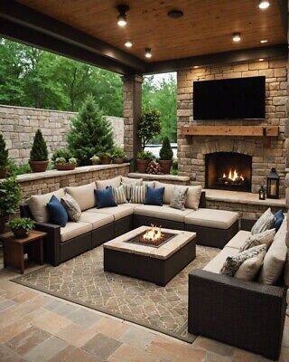 an outdoor living area with couches and fireplace