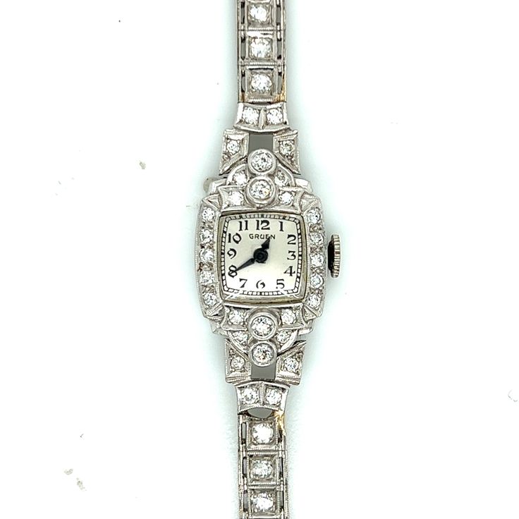 For a slender wrist, this all Platinum diamond line bracelet and case feels plush like silk... fitting on a wrist no larger than six inches in size. The case is set with diamonds on the bezel and shoulders; 13.15 pennyweights including the movement and crystal. The net platinum weight is 11.2 pennyweights / 17.4 grams.  Condition - The movement is in running order - keeps time within 5 minutes per day. The face is silvery white in clean condition. The Arabic numerals and blued steel hands are original with no visible rust or tarnish. The shoulders on both sides were repaired with gold solder. The photo exaggerates the color contrast between the gold solder and the platinum bracelet. 95% PLAT / 5% Ruthenium. If you can easily wrap a dollar bill around your wrist, this watch will fit you per Classic Diamond Bracelet For Evening, Classic Diamond Watch With Jubilee Bracelet For Formal Occasions, Classic Formal Diamond Watch With Jubilee Bracelet, Classic Diamond Bracelet With Accents For Evening, Classic Diamond Bracelet With Diamond Accents For Evening, Classic Evening Diamond Bracelet With Accents, Classic Wedding Watches In Diamond White, Classic White Gold Diamond Watch With Jubilee Bracelet, Classic Platinum Diamond Watch For Evening