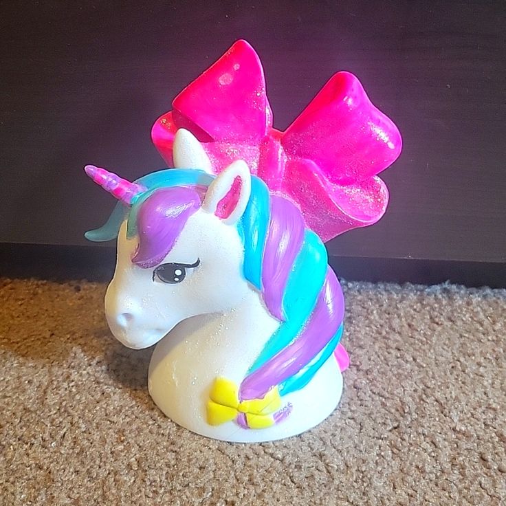 there is a small toy unicorn on the floor