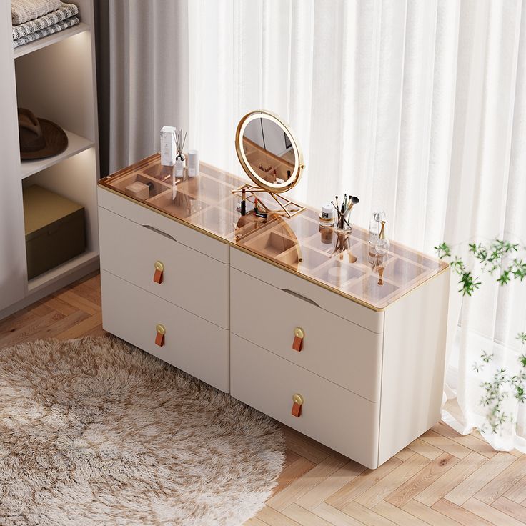 a white dresser with two drawers and a mirror on the top, in front of a curtained window