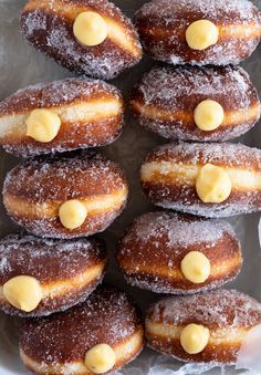 a bunch of doughnuts with icing on them are sitting in a pile