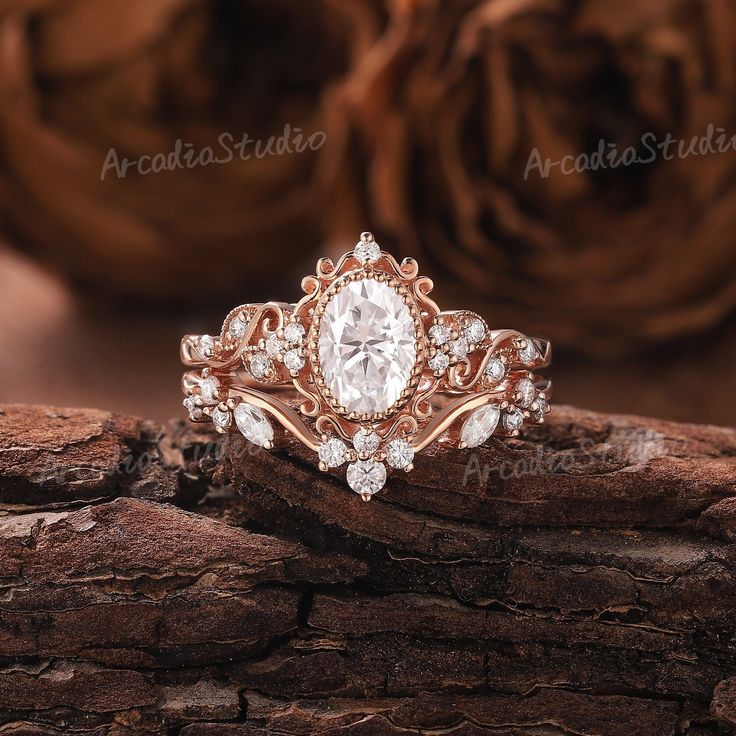 a close up of a ring on top of a piece of wood with roses in the background