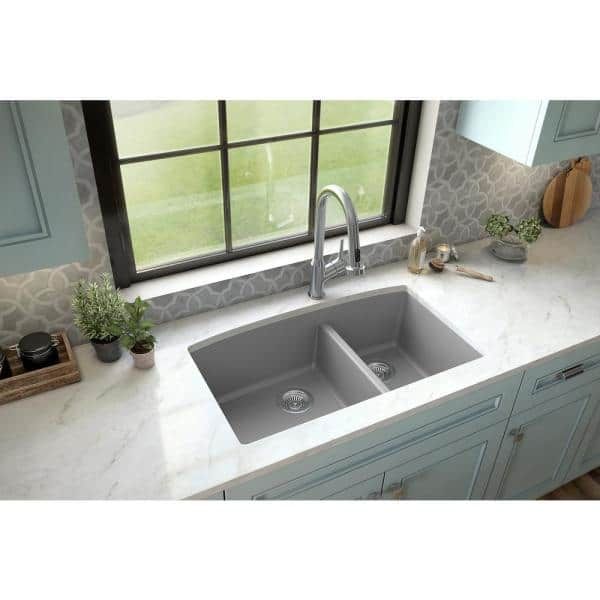 a kitchen sink with two faucets in the middle and a window behind it