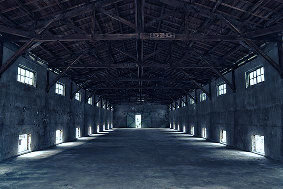 an empty warehouse with lots of windows in it