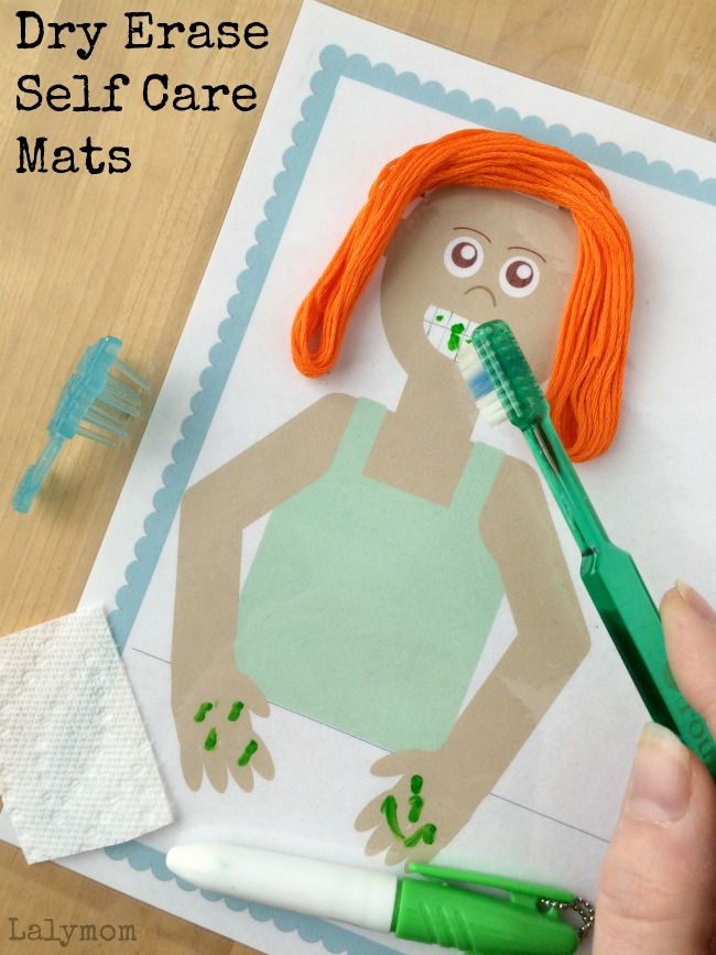 a person holding a toothbrush in front of a paper cut out of a woman