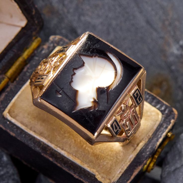 This vintage class ring features a centurion intaglio surrounded by details indicating the year of graduation, "1942." There is light wear to the intaglio. The ring is crafted in 10k yellow gold and is currently a size 11. Art Deco Cameo Ring For Collectors, Art Deco Cameo Ring Collectible, Art Deco Cameo Collectible Rings, Antique Intaglio Signet Ring Collectible, Antique Cameo Signet Ring For Formal Occasions, Victorian Style Cameo Signet Ring For Formal Occasions, Victorian Style Formal Signet Ring With Cameo, Vintage Cameo Signet Ring For Anniversary, Heirloom Intaglio Signet Ring For Formal Events