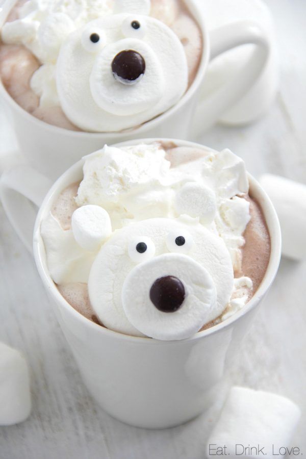 two cups filled with hot chocolate and marshmallows topped with polar bear faces