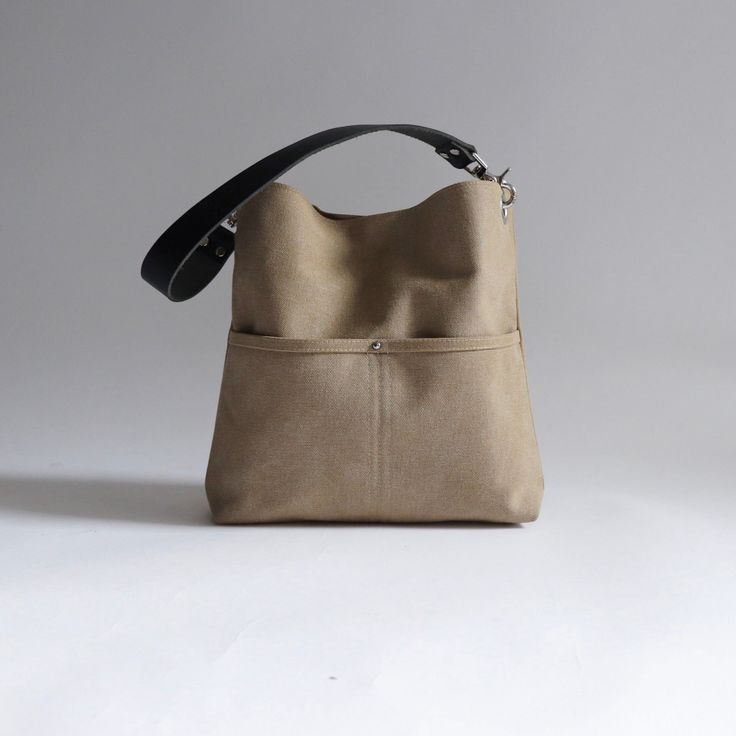 Urban-chic style crossbody bags that are neutral in color and effortlessly casual. When you need a mid-sized bag with easy access front pockets, just the right amount of not-too-slouchy shape and the perfect neutral shade, our updated take on the modern hobo bag is sized just right for everyday, on-the-go use. This listing is for the MEDIUM size bag in Khaki canvas. Khaki Shoulder Bag With Removable Pouch For On-the-go, Khaki Leather Shoulder Bag For On-the-go, Everyday Bucket Bag With Double Handle And Pockets, Chic Canvas Bag With Pockets For Everyday, Chic Everyday Canvas Bag With Pockets, Modern Khaki Tote Shoulder Bag, Chic Bucket Tote Bag With Pockets, Canvas Crossbody Bucket Bag With Pockets, Chic Bucket Bag Tote With Pockets