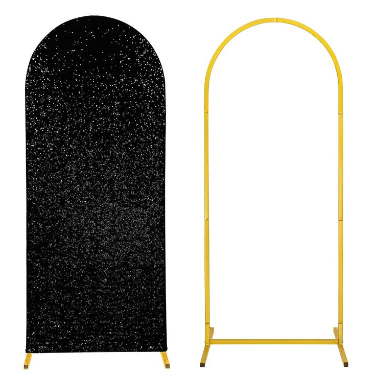 a black and gold arch stands next to it's yellow base, with the top half covered in glitter