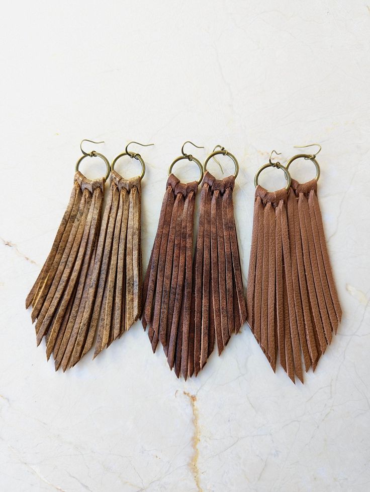 Long Fringe Leather Earrings- Leather Fringe Earring - Boho Earrings - Fringe Earrings - Tassel Earrings - Western Jewelry- Western Earrings - Gift This listing is for a handmade Genuine Leather Fringe Earrings with nickel free ear wires. Colors: Caramel Matte, Caramel pecan and brown chocolate soft shiny genuine leather * Leather measures approx 4 inches, with hook and circle charm approx 5 inches All earrings are handmade by yours truly! I have multiple sizes, shapes, patterns and colors available! Special requests are always welcome! I currently have multiple hooks available, if you have a preference of color or style, please don't hesitate to leave me a request in the "note to seller" box at checkout! Thank you for browsing my shop Shipping - Your item will be packaged with care and sh Adjustable Brown Bohemian Tassel Earrings, Brown Dangle Earrings With Tassels, Bohemian Brown Fringe Earrings, Bohemian Brown Beaded Tassel Earrings, Brown Fringed Tassel Earrings Gift, Brown Fringe Tassel Earrings As Gift, Brown Fringe Tassel Earrings For Gift, Brown Fringe Dangle Jewelry, Brown Fringe Tassel Dangle Earrings