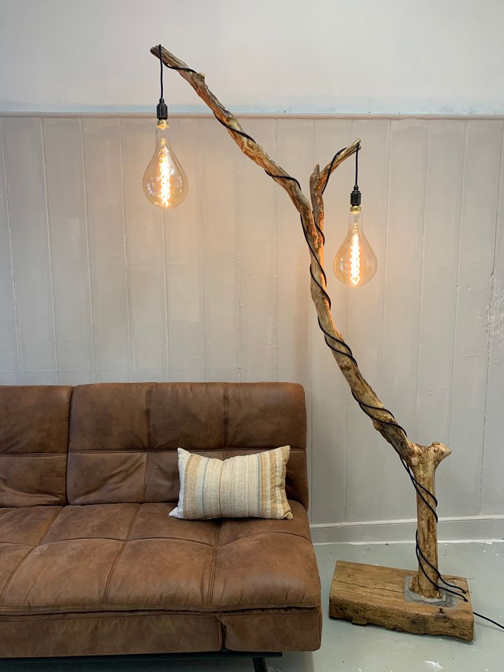 a living room with a brown couch and some lights