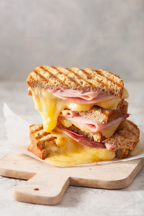 a grilled cheese sandwich with ham and melted cheese on toasted bread - stock photo - images