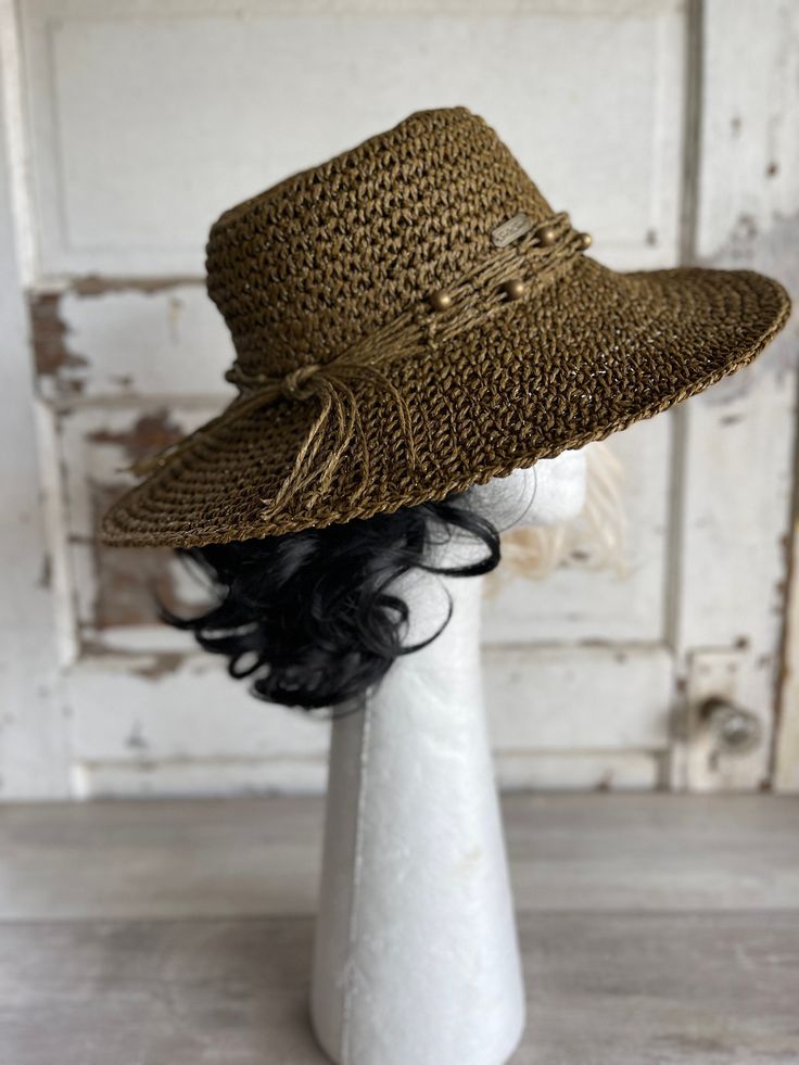 This floppy metallic woven sun hat features beaded accents ajustable elastic band a solid ring around the outside band grosgrain ribbon  and clear branding by Sun N Sand c. 1990s this was found a high end estate of a couple that boated frequently (and had a lot of hats)  This is in very good condition  and it is nice and floppy  but the simple ring around the band keeps it looking good not too floppy. A nice woven sun hat! Vintage Hat Boxes, Vintage Sun, Visor Hat, Simple Ring, Vintage Hats, Hat Box, Visor Hats, Vintage Souvenir, Beach Hat