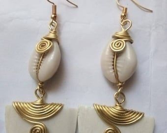 Wholesale African Women Earrings, Gift Jewelries, Cowries Shell Earrings - Etsy UK White Brass Earrings For The Beach, White Brass Earrings For Beach, Traditional Metal Jewelry For Beach, Bohemian Shell-shaped Earrings For Gift, Gold Cowrie Shell As Gift, Traditional Shell Jewelry As Gift, Traditional Shell Jewelry Gift, Elegant White Cowrie Shell Jewelry, Handmade White Shells For Jewelry Making