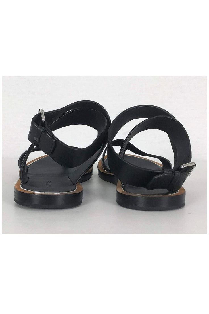 Chic sandals in black leather with an ankle strap design. Perfect for casual wear, style them with any dress or skirt. Size 6 - EU 36 Leather upper & sole Ankle strap design Silver-tone buckle Tan brown & silver trim Some wear on sole Light marks on leather Light creasing on leather Outsole length 9.5" Black Leather T-strap Sandals With Buckle Closure, Chic Adjustable T-strap Sandals With Buckle Closure, Chic Adjustable T-strap Sandals With Buckle, Black Leather T-strap Sandals With Ankle Strap, Casual Evening Sandals With Buckle Closure, Black Slingback Sandals With Strap And Open Heel, Black Slingback Sandals With Open Heel, Black Open Heel Slingback Sandals With Strap, Black Ankle Strap Sandals With Buckle Closure