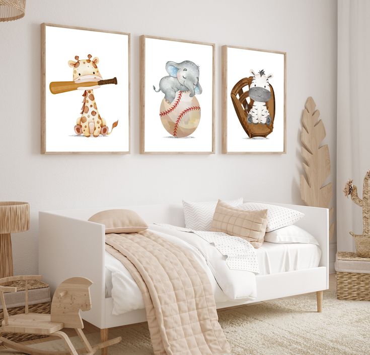 three framed pictures of animals and baseballs on the wall in a child's bedroom