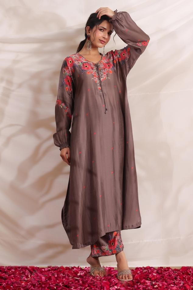 Brown silk asymmetric kurta with side pockets, multi color placement floral print, sequin, bead and French knot thread embroidered highlights. Paired with palazzo with printed border.
Components: 2
Pattern: Printed and Hand Embroidered
Type Of Work: Bloom Print, Bead, Sequin and French Knot Thread Work
Neckline: V Neck
Sleeve Type: Puff Sleeves
Fabric: Silk
Color: Brown
Other Details: 
Embroidered yoke
Curved hem
Side slits
Embroidered highlights
Model height: 5ft inches, wearing size S
Kurta Cl Festive Tissue Silk Sets With Printed Motifs, Silk Salwar Kameez With Printed Motifs For Wedding, Wedding Silk Salwar Kameez With Printed Motifs, Elegant Printed Dupatta For Navratri, Traditional Tissue Silk Sets With Printed Motifs, Wedding Kurta In Raw Silk With Printed Motifs, Wedding Kurta With Printed Motifs In Raw Silk, Tissue Silk Traditional Wear With Printed Motifs For Wedding, Raw Silk Wedding Sets With Printed Motifs