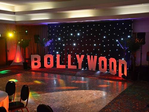 the hollywood sign is lit up in front of an audience at a party or event