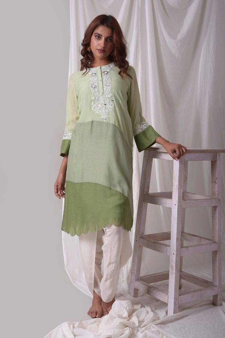 Beautiful sage green cotton silk suit is a stunning choice for weddings and festive occasions! The suit is crafted with fine simple white design work. Kurta has 3/4 length sleeves which has dark green border with white design. Kurta has multi color light green on top and dark green on bottom. It has a complementing white color dhoti. The suits simplicity gives it a unique and lovely look. Buy online from Pure Elegance. Disclaimer: The actual product may vary slightly from the image. These are cu Design Kurta, Green Border, Fashion Journals, Pure Elegance, Silk Suit, Traditional Fabric, Simple White, Designer Gowns, White Design