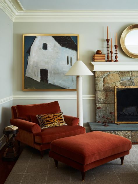 a living room filled with furniture and a fire place in front of a painting on the wall