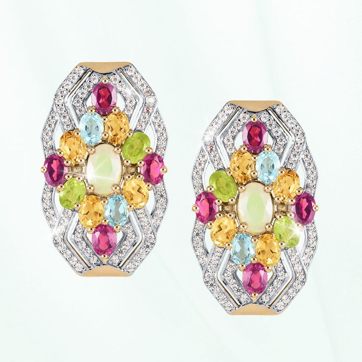 A celebration of artistry and color. Finely crafted from sterling silver, finished in 18k yellow gold, this ornate ensemble is a testament to your timeless style. An intricate arrangement of colorful gemstones, each chosen for its unique charm creates a charming focal point. An opulent Opal sits at the heart, surrounded by radiant Rhodolites, warm Citrines, refreshing Peridots and serene Blue Topaz. The dynamic interplay of hues creates a mesmerizing kaleidoscope that captures attention and sparks conversation. Embrace the enchantment of this collection and let your style speak volumes with every step. Fine Jewelry Multicolor Oval Gemstones, Opulent Gemstone Jewelry For Anniversary, Exquisite Multicolor Oval Jewelry, Multicolor Oval Jewelry With Accent Stones, Multicolor Gemstone Fine Jewelry, Dazzling Multicolor Multi-stone Jewelry, Heirloom Multicolor Oval Jewelry, Exquisite Multi-stone Yellow Gold Jewelry, Multicolor Gemstone Accented Fine Jewelry Earrings