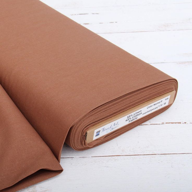 a rolled up brown cloth on top of a white wooden floor