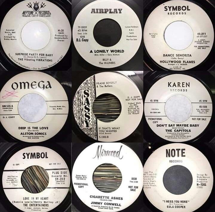 nine different records are stacked on top of each other, with the same label in black and white