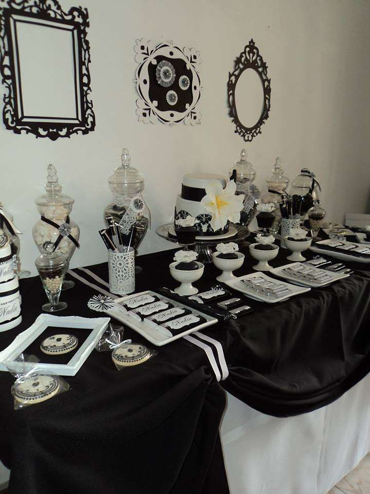 the table is set up with black and white decorations