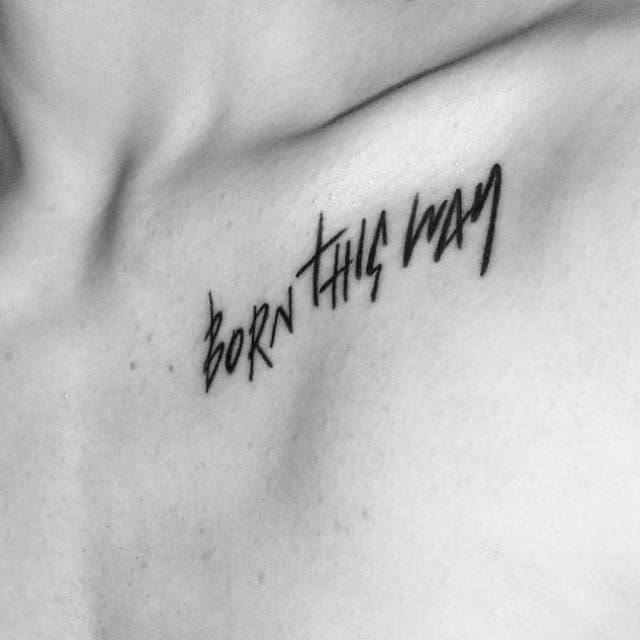 a tattoo that reads born this way on the chest