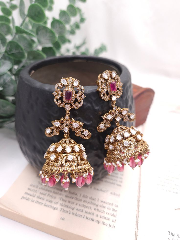 Fine Victorian Kundan Jhumka with CZ stones and uncut Polki Kundan stones Surely a statement Jhumka earringThe earring has very fine quality and craftmanship and also has a very elegant look pictures cannot do justice to how beautiful this jhumka earrings is . Luxury Traditional Ruby Jhumkas, Temple Jewelry Style Danglers With Stone Work For Reception, Reception Temple Jewelry Danglers With Stone Work, Festive Stone Work Chandelier Earrings For Reception, Intricate Design Dangle Earrings For Reception, Temple Jewelry Style Chandelier Earrings For Reception, Festive Chandelier Earrings With Stone Work For Reception, Dangle Earrings With Intricate Design For Reception, Intricate Design Drop Earrings For Reception