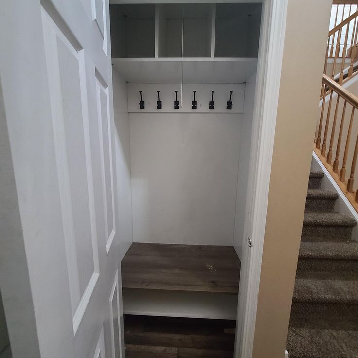 an empty entryway with stairs leading up to the second floor