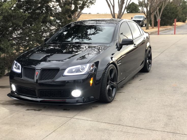 a black car is parked on the street