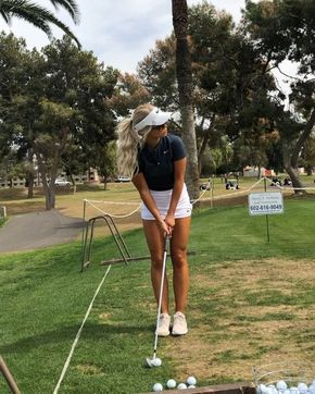 a woman is playing golf on the grass