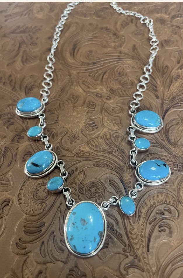 Beautiful Handmade Turquoise and Sterling Silver Cluster Necklace. Such gorgeous stones in this piece! Necklace measures 18 inches long. Stamped Sterling & Signed Nizhoni. WILL VARY **NON NATIVE** Thank you for looking at our items. Please contact us if you have any questions.