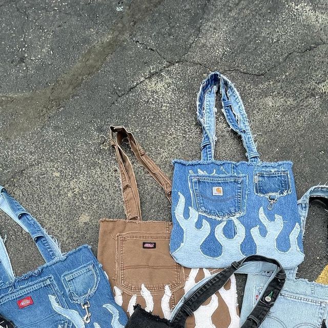 four denim purses sitting on the ground next to each other with different designs and colors