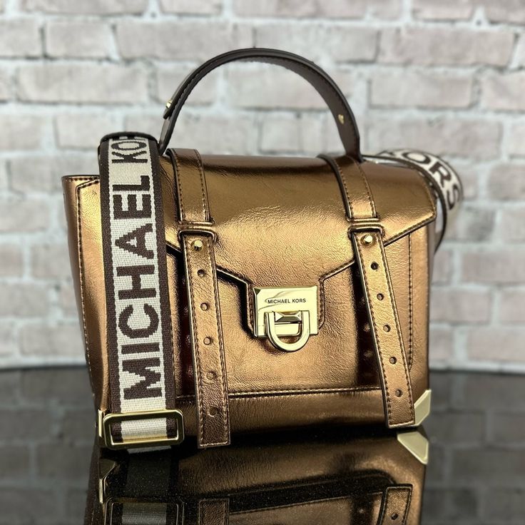 Michael Kors Manhattan Crossbody Satchel Bag 100% Authentic New With Tags Retail Price: $598.00 + Tax Gold-Tone Hardware 10"W X 7.25"H X 4"D Adjustable Strap: 19”-21” Exterior Details: Front Slip Pocket Interior Details: Back Zip Pocket, Front Slip Pocket Flip-Lock Fastening Designer Cognac Satchel With Adjustable Strap, Gold Satchel With Metal Hardware For Shopping, Gold Travel Satchel With Branded Hardware, Designer Cognac Bag With Metal Hardware, Gold Satchel With Gold-tone Hardware For On-the-go, Cognac Satchel Bag With Branded Hardware, Cognac Bags With Branded Hardware For Everyday Use, Gold Satchel With Top Handle And Metal Hardware, Luxury Cognac Satchel With Adjustable Strap