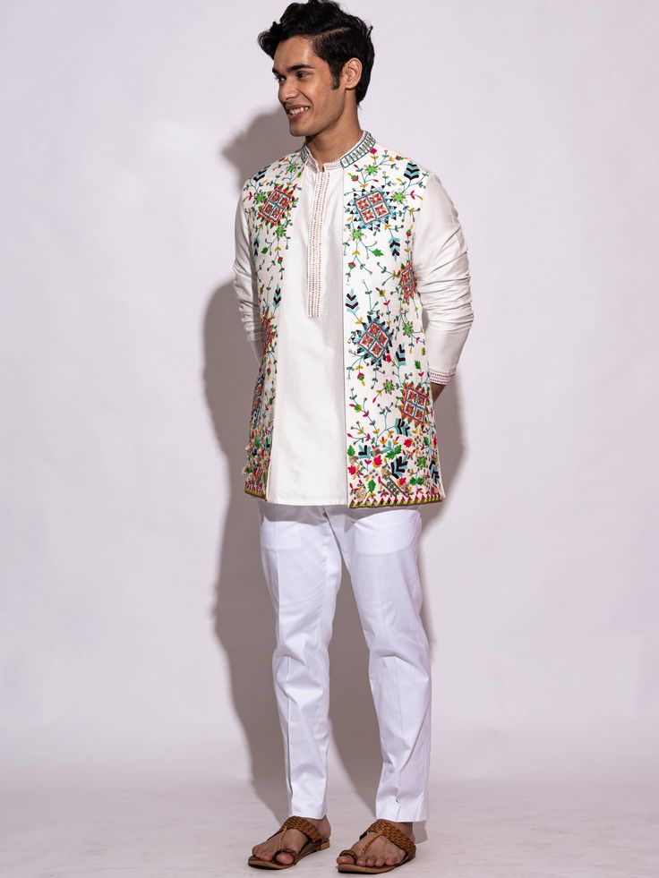 This White Floral Kurta Bundi Set will instantly give an elegant look. This 3 piece kurta bundi set features a white silk embroidered bundi jacket with heavy floral embroidery, thread sequence work using mirror-sequin, a white silk kurta, invisible front button placket, and a mandarin collar. It is paired with white slim-fit pants. An ideal outfit for traditional occasions, and special events.

Size Chart For Men





	
	
					Men's Size Chart
		

		
		
						
				Size Chart For Men
				Custom S Men Fashion Photo, Men Kurta, Wedding Branding, Silk Kurta, Sequence Work, Slim Fit Pants, Fit Pants, White Silk, Embroidered Silk