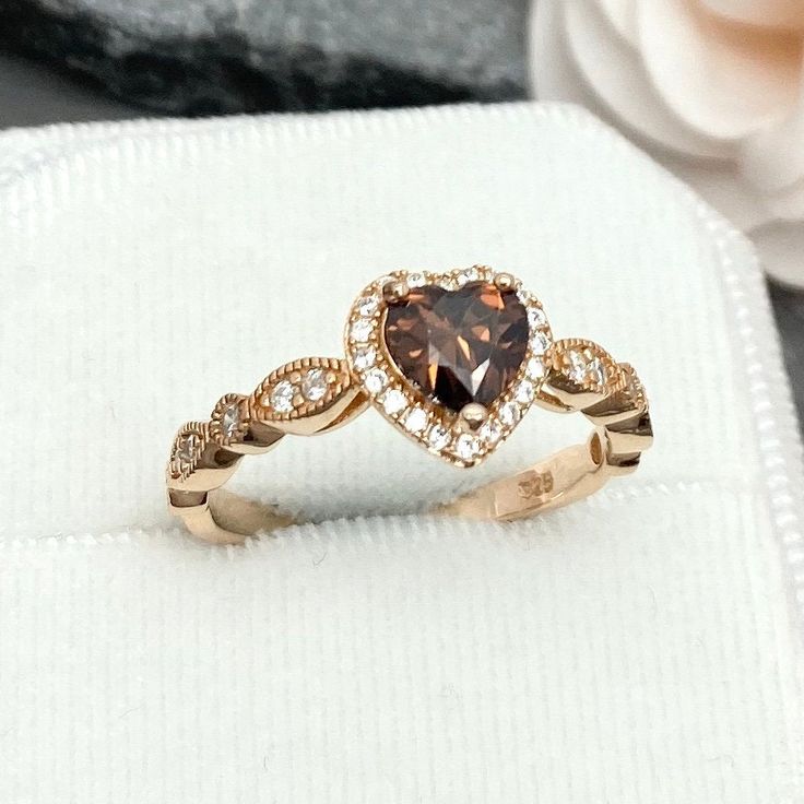 This beautiful ring is made from genuine 925 sterling silver with rose gold plating. Ring details- -The Main stone is a heart shape 6mm Chocolate Brown Simulated Diamonds -Side stones are round 1.5mm and 1.1mm simulated diamonds -Ring is casted in solid 925 sterling silver with rose gold plating (yellow gold and rhodium plated also available, please check the drop down menu for more options) -The Total face height of the ring measures 8mms and the band width measures 2mms -Each ring is handmade, 14k Rose Gold Heart-shaped Anniversary Ring, 14k Rose Gold Heart Ring For Anniversary, Heart-shaped 14k Rose Gold Anniversary Ring, Luxury Rose Gold Heart Cut Ring, Luxury Rose Gold Heart Ring For Valentine's Day, Rose Gold Sterling Silver Heart Ring For Valentine's Day, 14k Rose Gold Heart-shaped Ring Gift, 14k Rose Gold Heart Ring For Gift, 14k Rose Gold Heart Ring As Gift