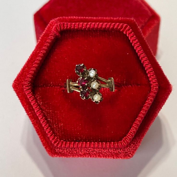 Stunning antique Victorian era 14k rosey gold genuine garnet and seed pearl ring! This gorgeous piece showcases three round cut genuine garnets with an estimated .33 ctw. with three seed pearls on the other side. An incredible piece of fine antique jewelry, circa 1800s!  ERA - Circa 1800 -Victorian  METAL / MATERIAL - 14k rosey gold, 3 genuine garnet ( approx. .33 ctw), 3 seed pearls  MARKINGS / HISTORY - NA CONDITION - Good antique condition. Ring has been cleaned and lightly polished. Surface wear and patina consistent with age remains. An amazing antique ring!  SIZE / MEASUREMENTS - Size: 6, Ring Head: 12.1 mm, Rise Of Ring Off Finger: 5.3 mm, Shank: tapers to 2.3 mm, Weight: 2.37 grams Vintage Multi-stone Ruby Ring In 14k Gold, Victorian Cluster Ring With Multi-stone, Victorian Multi-stone Cluster Ring, Victorian Style Pearl Ring Gift, Victorian Gemstone Cluster Wedding Ring, Victorian Pearl Ring Gift, Victorian Gemstone Cluster Ring For Wedding, Victorian Pearl Ring Gemstone Gift, Victorian Pearl Ring With Gemstone For Gift