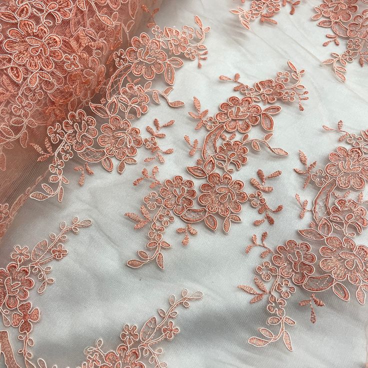 "Make any special occasion pop with our stunning Corded Bridal Lace Fabric Embroidered on 100% Polyester Net Mesh. This beautiful fabric is perfect for creating wedding dresses, evening gowns, and dance costumes that will be sure to make a lasting impression. Whether you're looking for a unique way to celebrate a quinceanera, an elegant bridal style, or a festive costume with a couture touch, our Corded lace fabric has the perfect combination of features to help bring your vision to life. Our Co Festive Ceremony Dress With Lace Work, Elegant Pink Fabric With 3d Embroidery, Festive Lace Embroidered Gown, Festive Floral Embroidered Lace Gown, Festive Embroidered Lace Gown, Pink Floral Embroidered Wedding Gown, Festive Lace Gown With Floral Embroidery, Festive Lace Gown With Embroidery, Wedding Dresses With 3d Embroidery And Lace