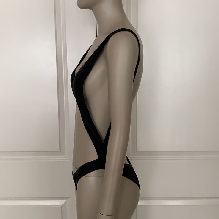 Removable Padding In Bust. Fully Lined In Front. New. Black Low-back Bodysuit For The Pool, Black Low-back Bodysuit For Pool, Black Low Back Bodysuit For Pool, Black Swimwear With Built-in Bra And Low Back, Black Low Back Swimwear With Lined Body, Black Low Back Lined Swimwear, Black T-back Swimwear For Party, Black Triangle Top Bodysuit For Swimming, Black T-back Party Swimwear